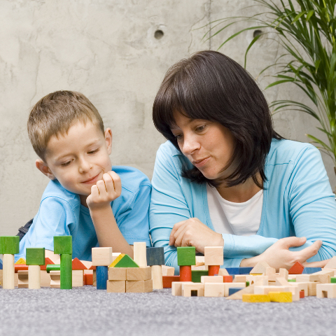 Parent interacting with child through play.